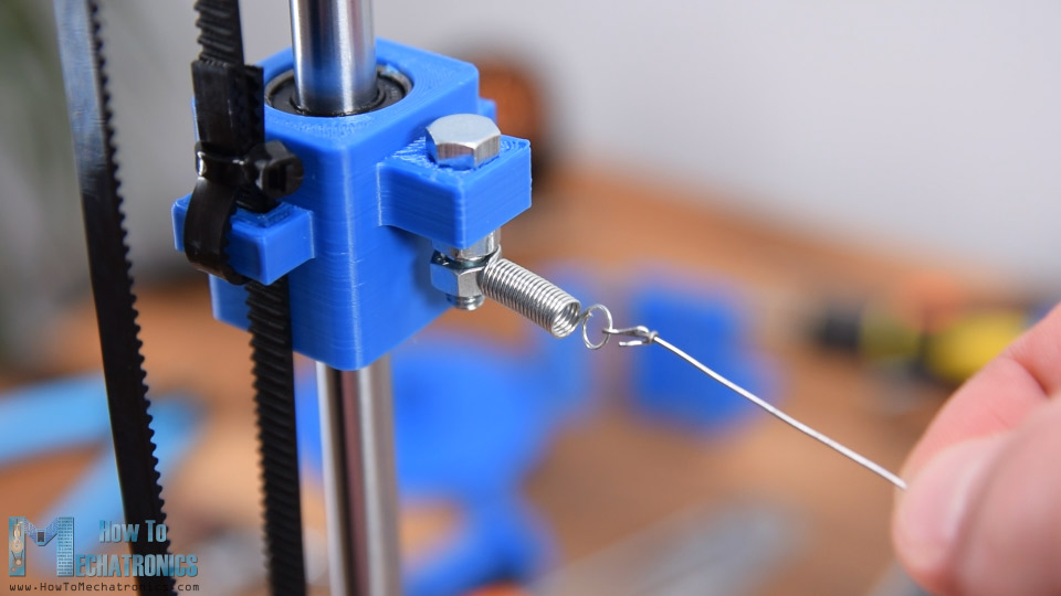 Attaching the hot wire to the Y-axis sliding block with help of extension springs