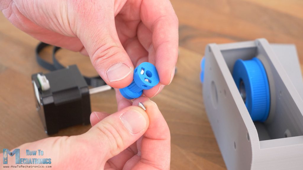 3D Printed GT2 pulley with slots for nuts for securing it to a NEMA 17 shaft with grub screws